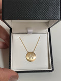Diamond letter set in 14k matte gold disk necklace