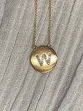 Diamond letter set in 14k matte gold disk necklace