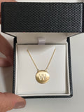 Diamond letter set in 14k matte gold disk necklace