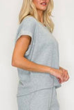 Cozy waffle knit short sleeve top available in navy and h. Grey