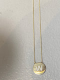Diamond letter set in 14k matte gold disk necklace