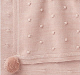 Popcorn stitch blush baby blanket with pom pom edges